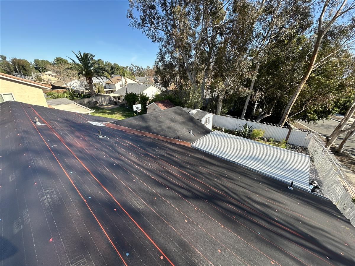 Roof underlayment installation in progress